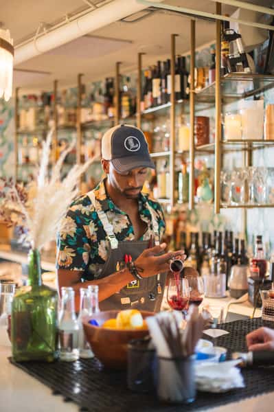 Employee mixing drinks at bar