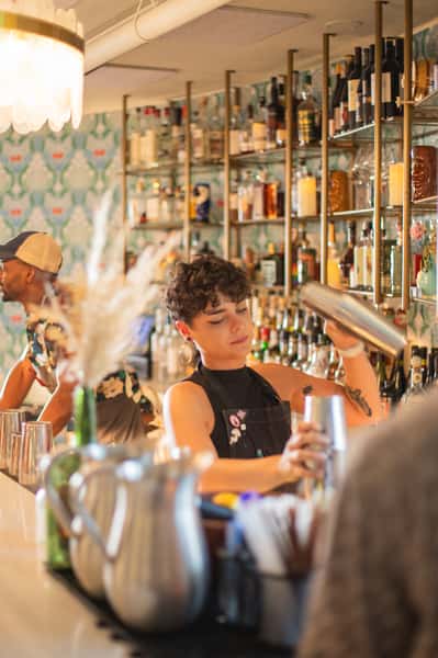 Bartender pouring mixed drink for customer