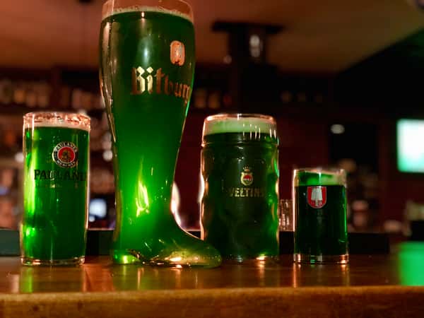 Green colored beer in German steins