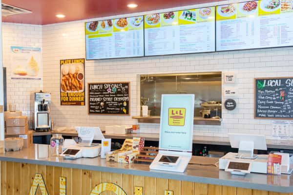 Front ordering counter with cash register and digital menus at L&L Hawaiian