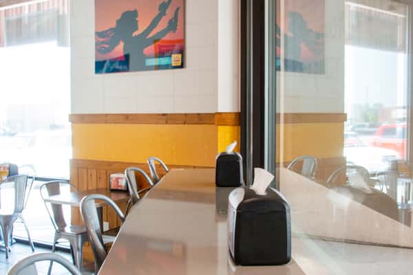 Bar countertop seating along a wall inside L&L Hawaiian Barbecue