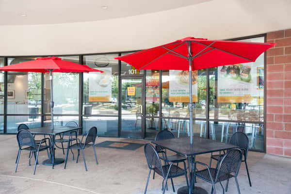 Outdoor patio dining area with tables, chairs and umbrellas