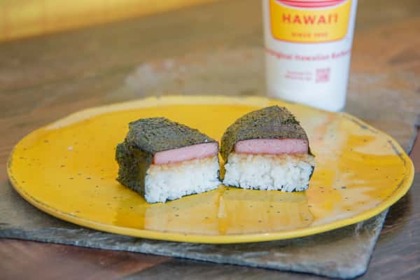 Two pieces of spam musubi on a yellow plate