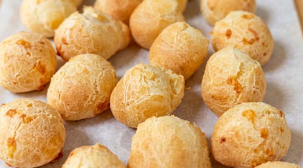 Authentic Brazilian cheese bread (pão de queijo) baked golden and fluffy, a traditional gluten-free favorite at Brazilian Family Bakery.