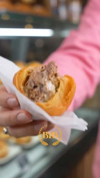 Authentic Brazilian beef pastry with a flaky golden crust and savory shredded beef filling, served fresh at Brazilian Family Bakery.