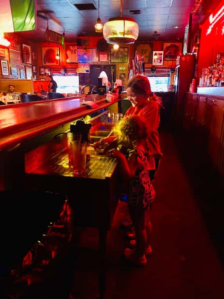 kids at table inside bar with lights