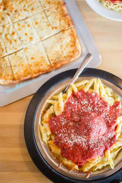 spaghetti with meatballs and a flatbread with cheese