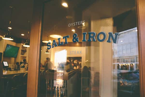 glass door with Salt & Iron logo