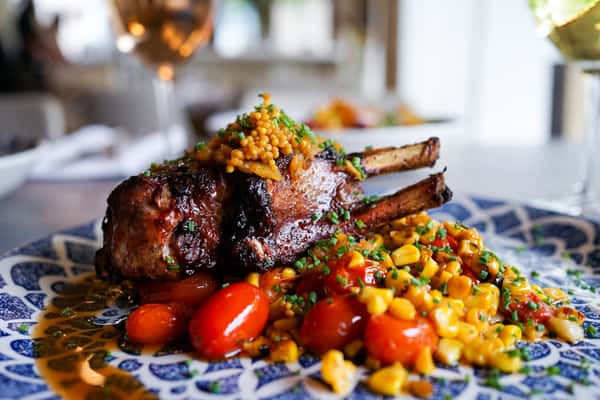 pork chop with tomato and vegetable garnish