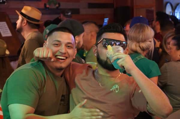 men drinking green beer