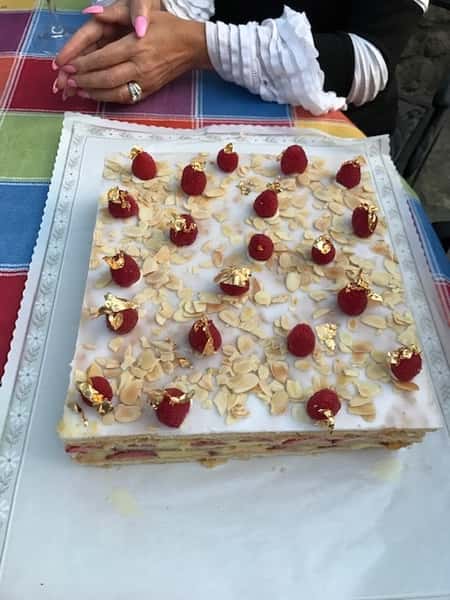 Raspberry cake topped with raspberries and almonds
