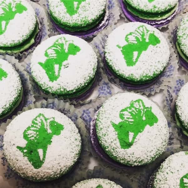 assortment of Tinkerbell cupcakes topped with powdered sugar