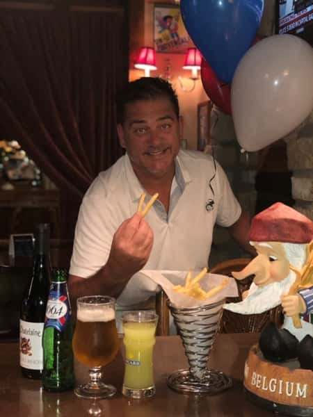 man holding fries posing for a picture