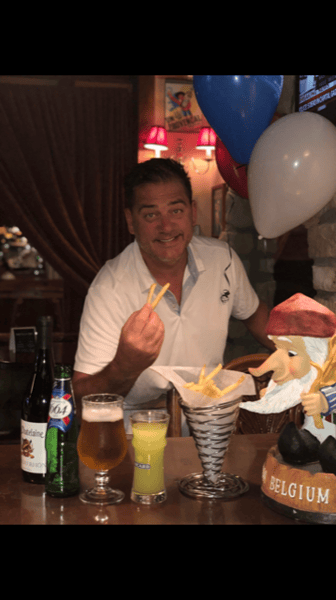 man holding fries posing for a picture