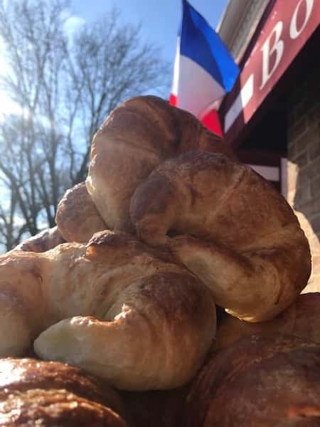 assortment of croissants with a french flag in the background