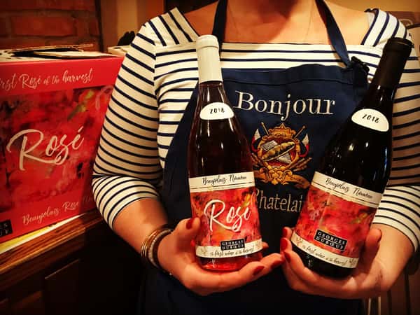 La Chatelaine server holding two bottles of Rose wine