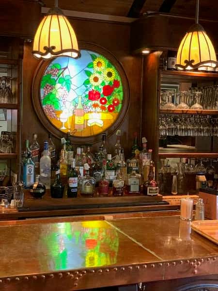 an assortment of alcoholic beverages behind the bar
