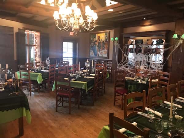 set tables with glasses and forks and knives