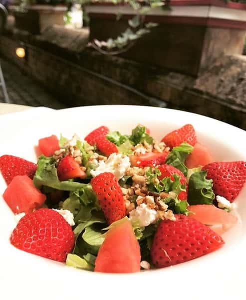 strawberry and watermelon salad topped with feta cheese and walnuts
