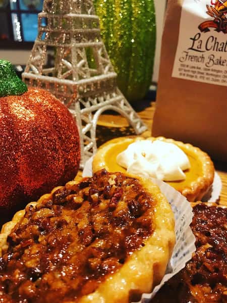 assortment of pies with a pumpkin decorations