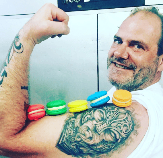 Employee with Macaroons displayed on his bicep