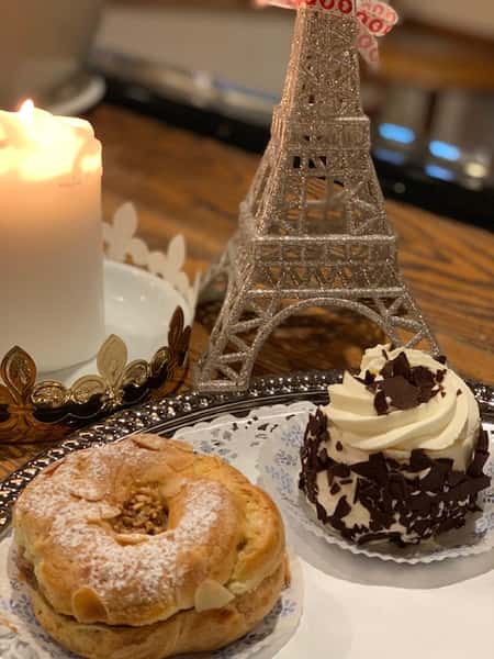 miniature eifel tower on a table with pastries