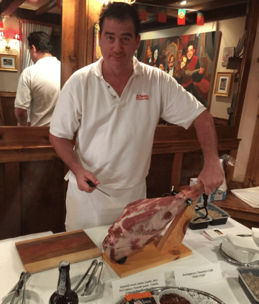 employee cutting a piece of meat