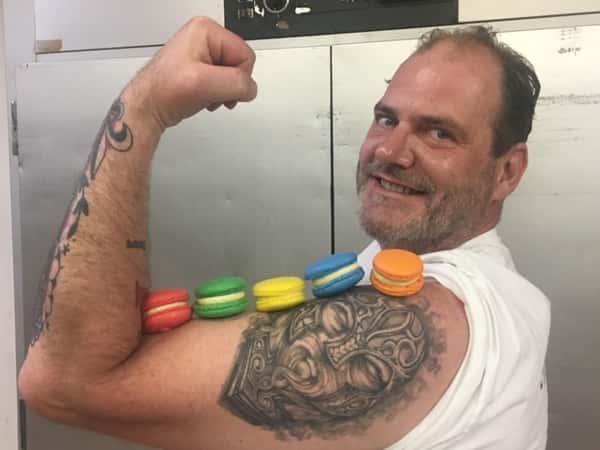 Employee with Macaroons displayed on his bicep
