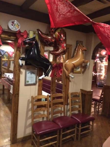 3 horse balooons with chairs in front of a mirror