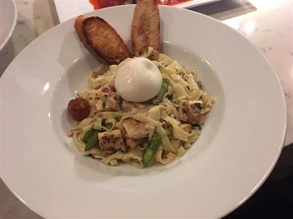 pasta in a bowl with chicken and bread