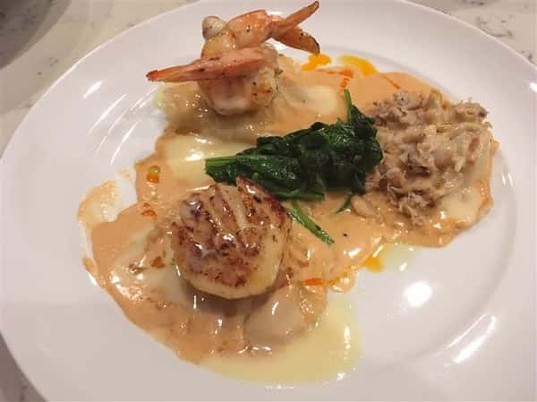 seafood dish with spinach and sauce