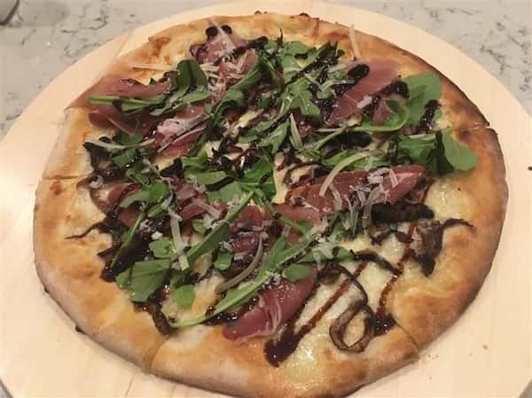 pizza with meat, lettuce and sauce