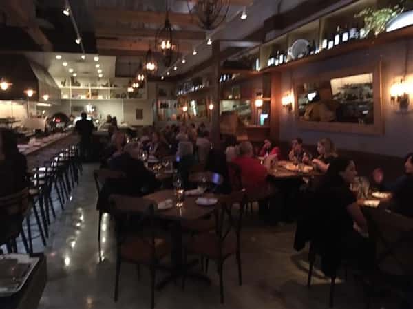 inside panevino osteria showcasing a crowded night in the dining area