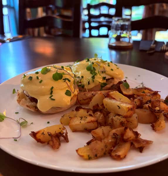 Classic Egg Benedicts with fresh herbs and home style potatoes
