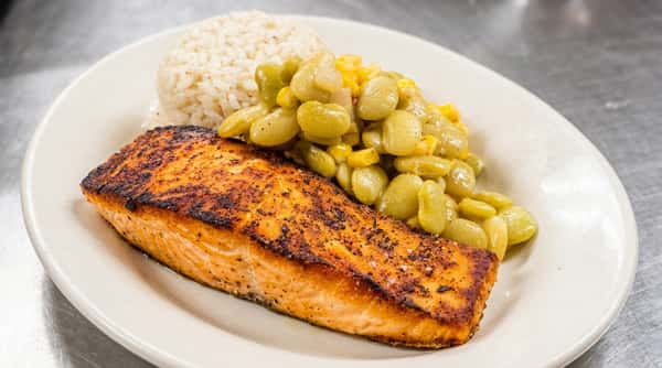 Pan-seared salmon with a side of white rice and lima beans mixed with corn.
