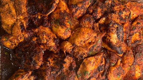 Juicy grilled chicken thighs seasoned with a smoky, spicy dry rub and charred to perfection.