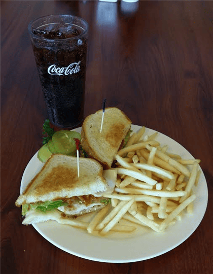 Chicken, lettuce, and bacon sandwhich with a side of fries