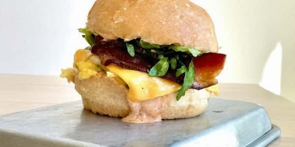 Egg sandwich with salad and bacon