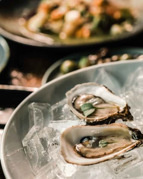 Raw PEI oysters on ice, served with cava mignonette and seaweed ponzu
