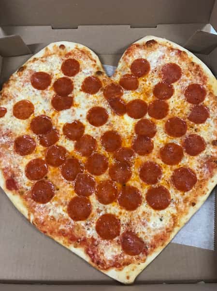 a freshly baked pepperoni pizza pie in the shape of a heart