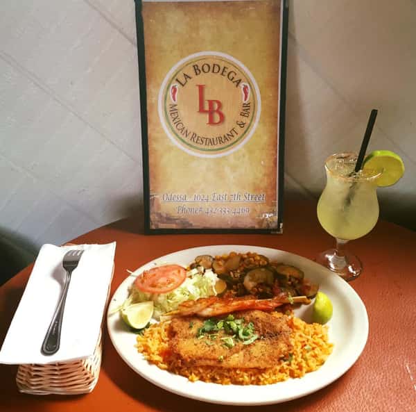 rice and vegetable dish served with a margarita