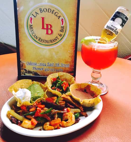 grilled shrimp and vegetable dish with sour cream, guacamole and refried beans sides, served with a mixed drink