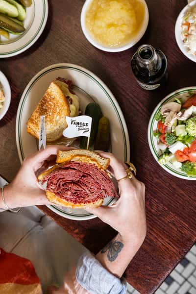 Famous 4th Street Deli's stacked pastrami sandwich on rye — iconic Philadelphia Jewish-style deli favorite.
