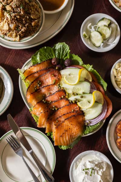 Smoked salmon and bagel platter with cucumbers, onions, and capers at Famous Deli — classic Jewish-style brunch in Philly.