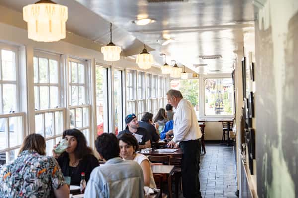 Guests enjoying lunch at Famous 4th Street Delicatessen dining room in Queen Village — authentic Jewish-style dining experience in Philadelphia.