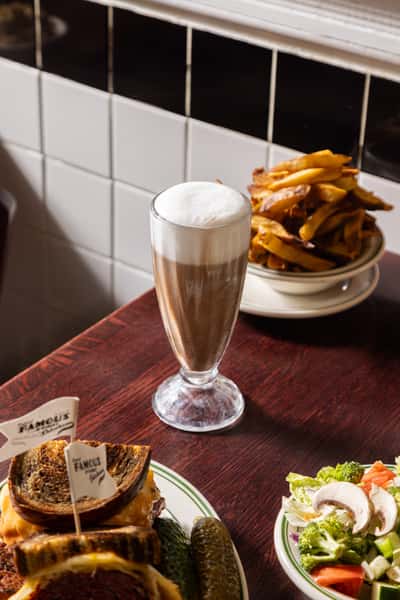 Classic New York-style chocolate egg cream and fries at Famous 4th Street Deli — nostalgic Jewish deli favorite in Philadelphia.