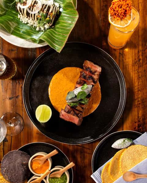 Top view photo of creamy meat dish served with drinks