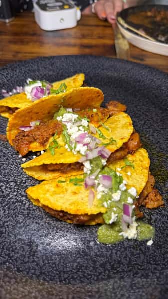 Close up of tacos with a sauce spread over