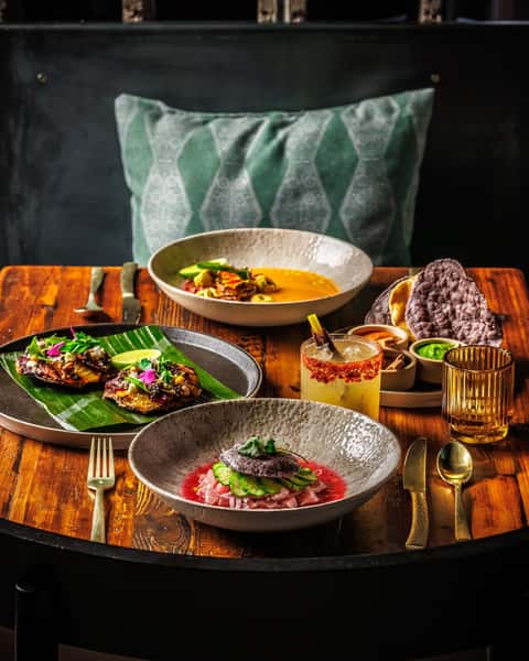 Mixed Mexican food spread on a dark wooden table
