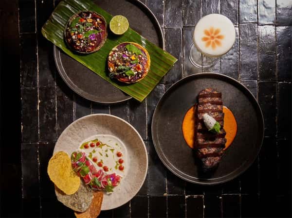 Mixed Mexican food spread on a dark wooden table